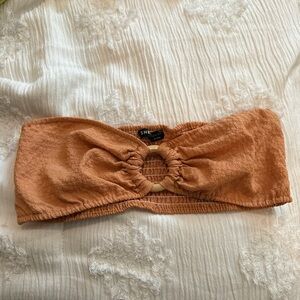 Orange bandeau top with a wooden connector. Size: US 4